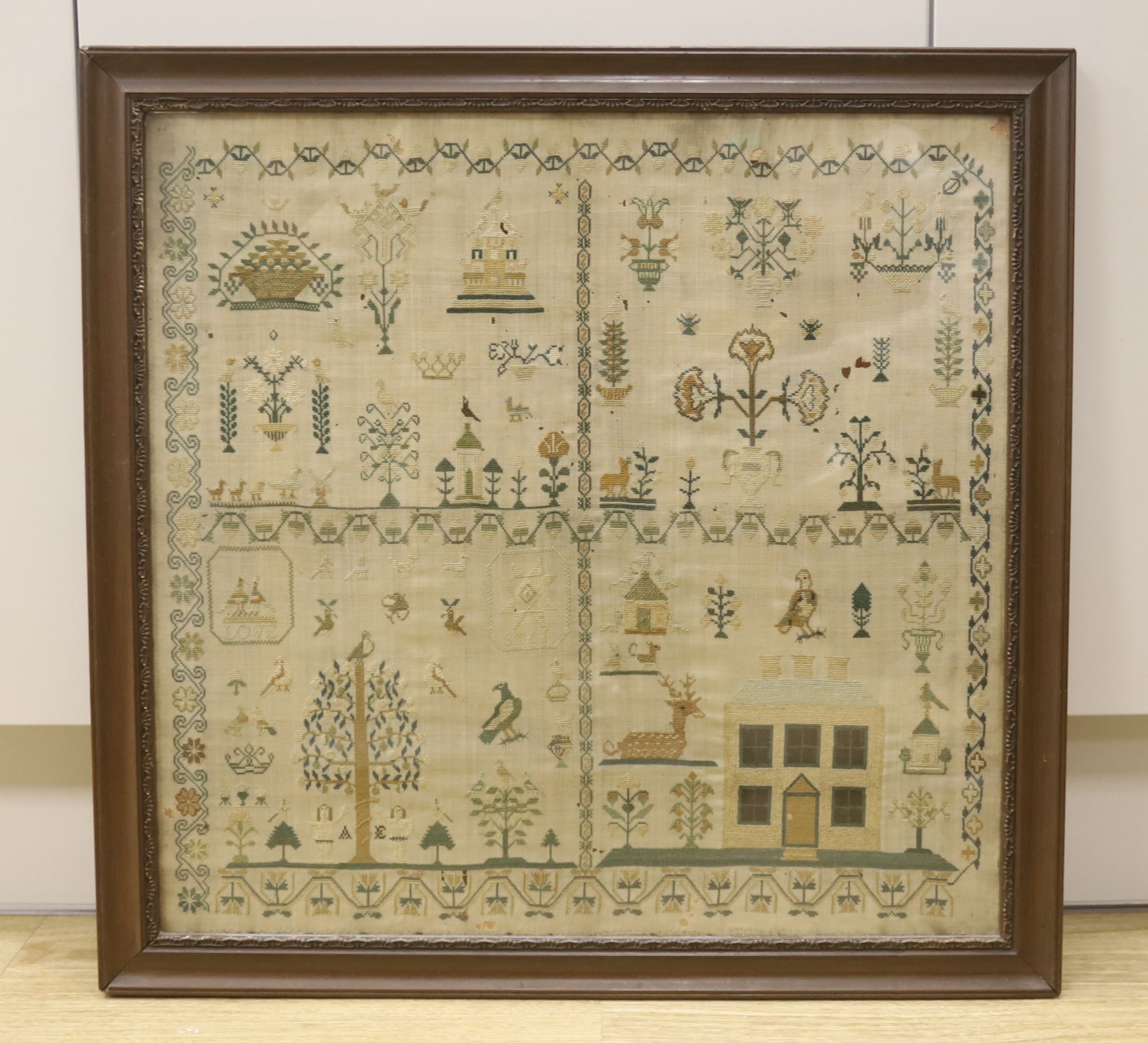 A large late 18th century needlework sampler, worked with birds, animals and shrubs, a country house, the motto, 